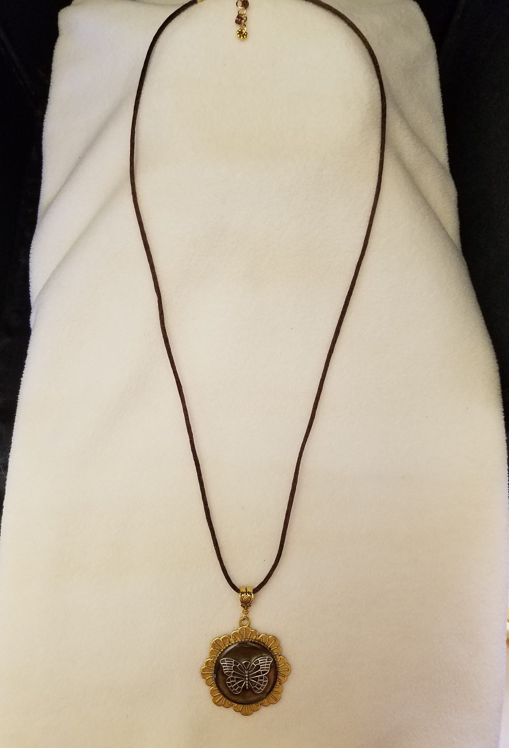 Brown Cord Adjustable Necklace with Silver Butterfly Set in Brown Epoxy on Gold Flower Pendant