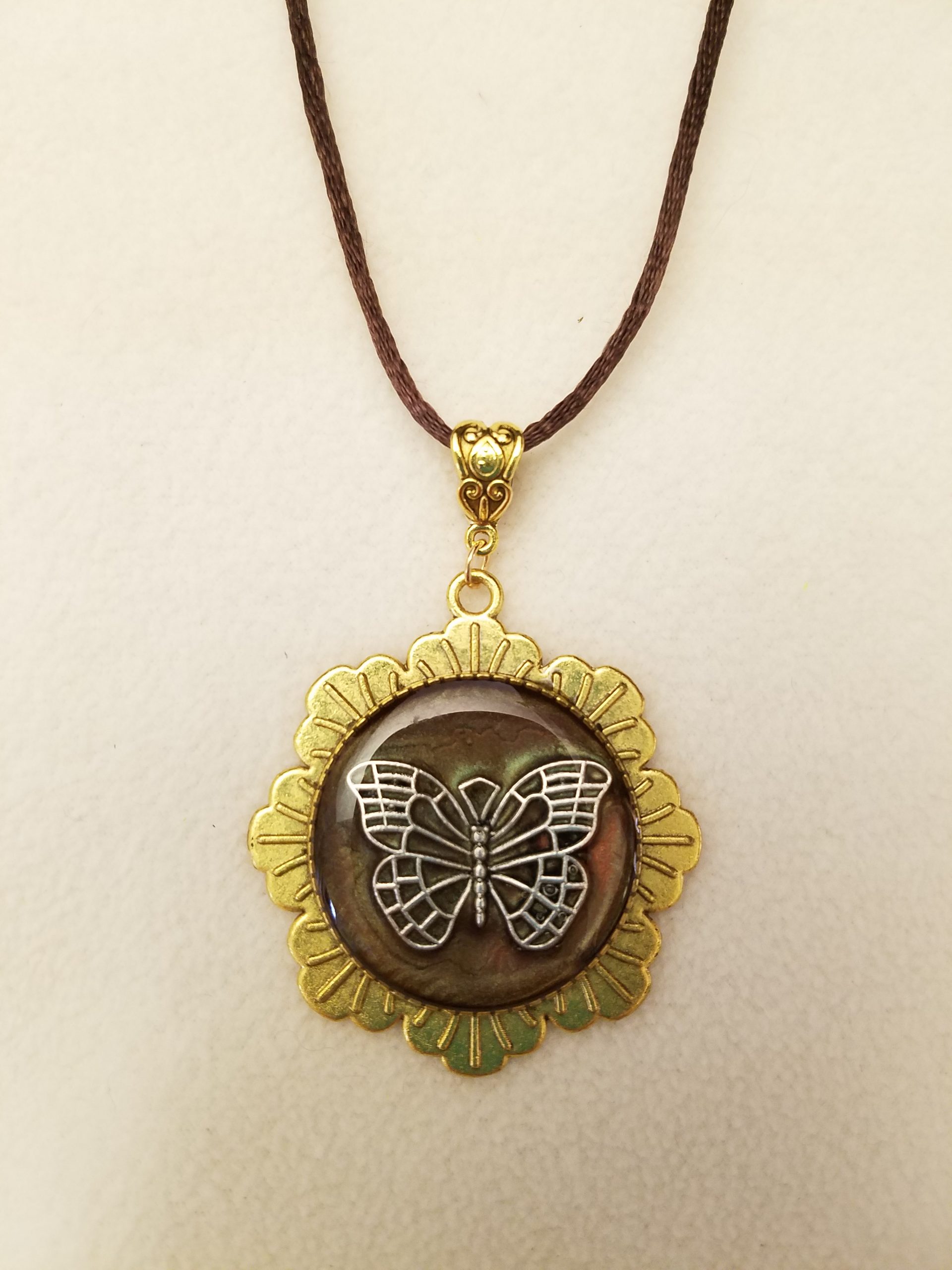 Silver Butterfly Set in Brown Epoxy on Gold Flower Pendant