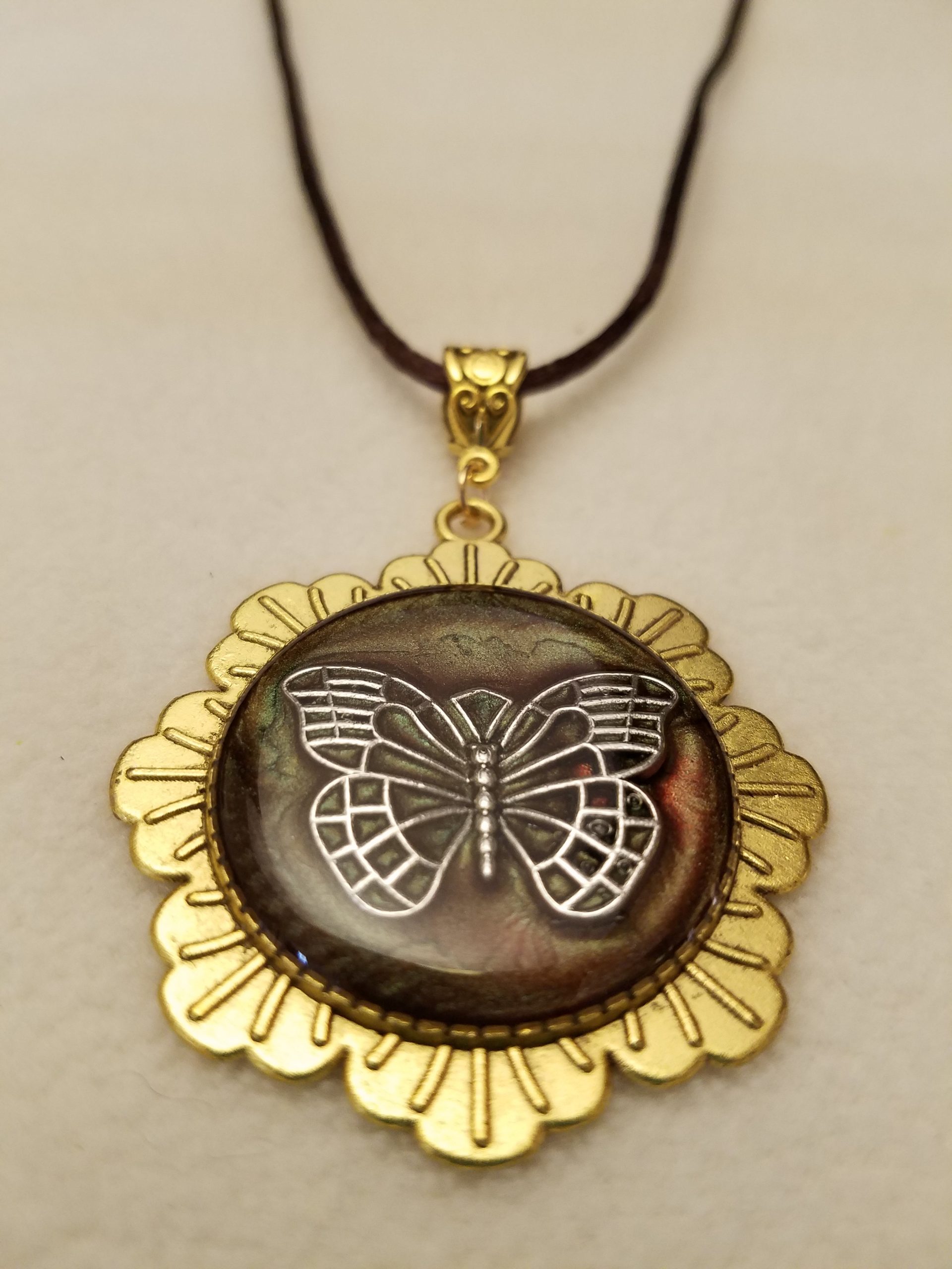 Silver Butterfly Set in Brown Epoxy on Gold Flower Pendant