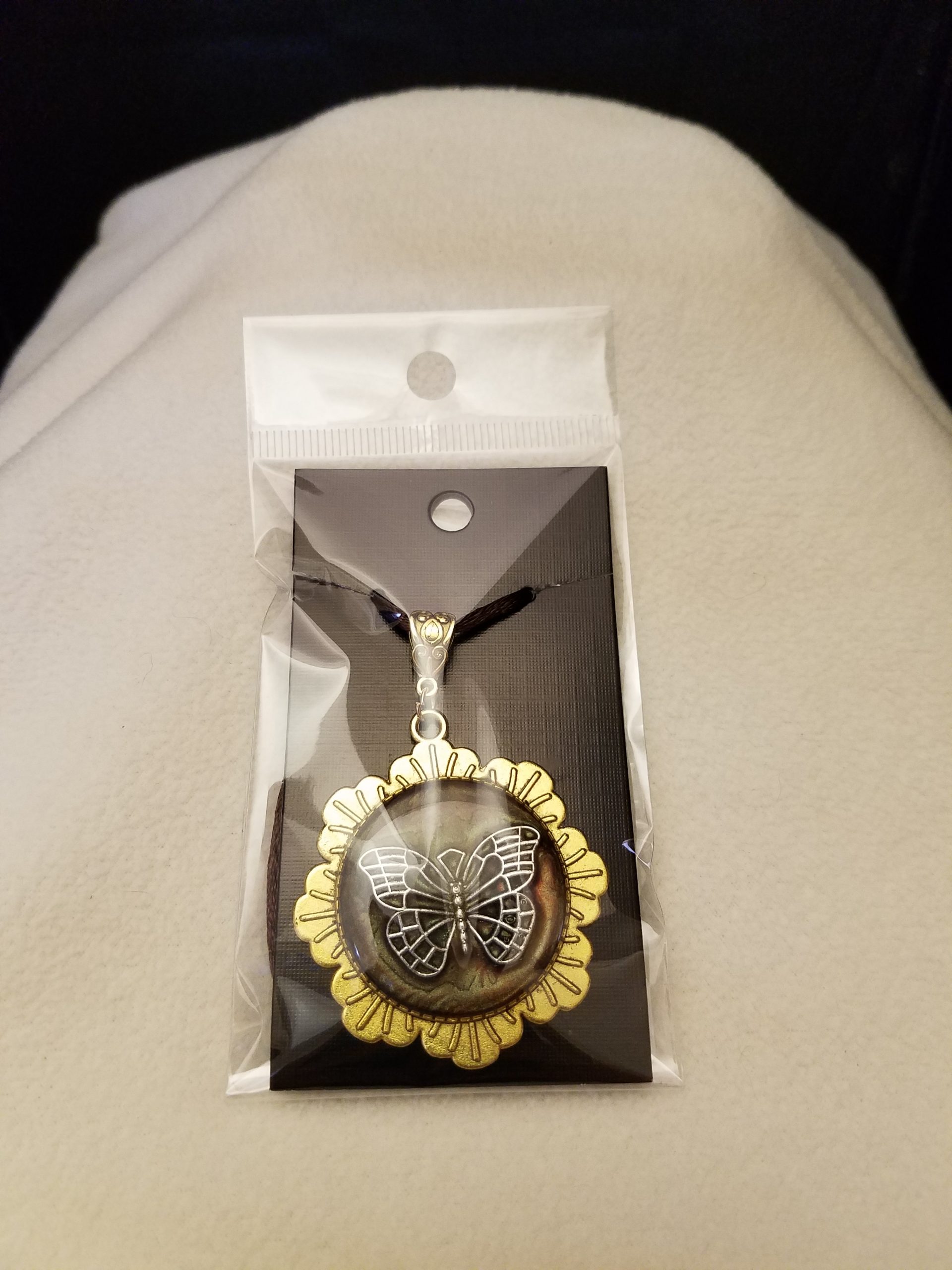 Brown Cord Adjustable Necklace with Silver Butterfly Set in Brown Epoxy on Gold Flower Pendant