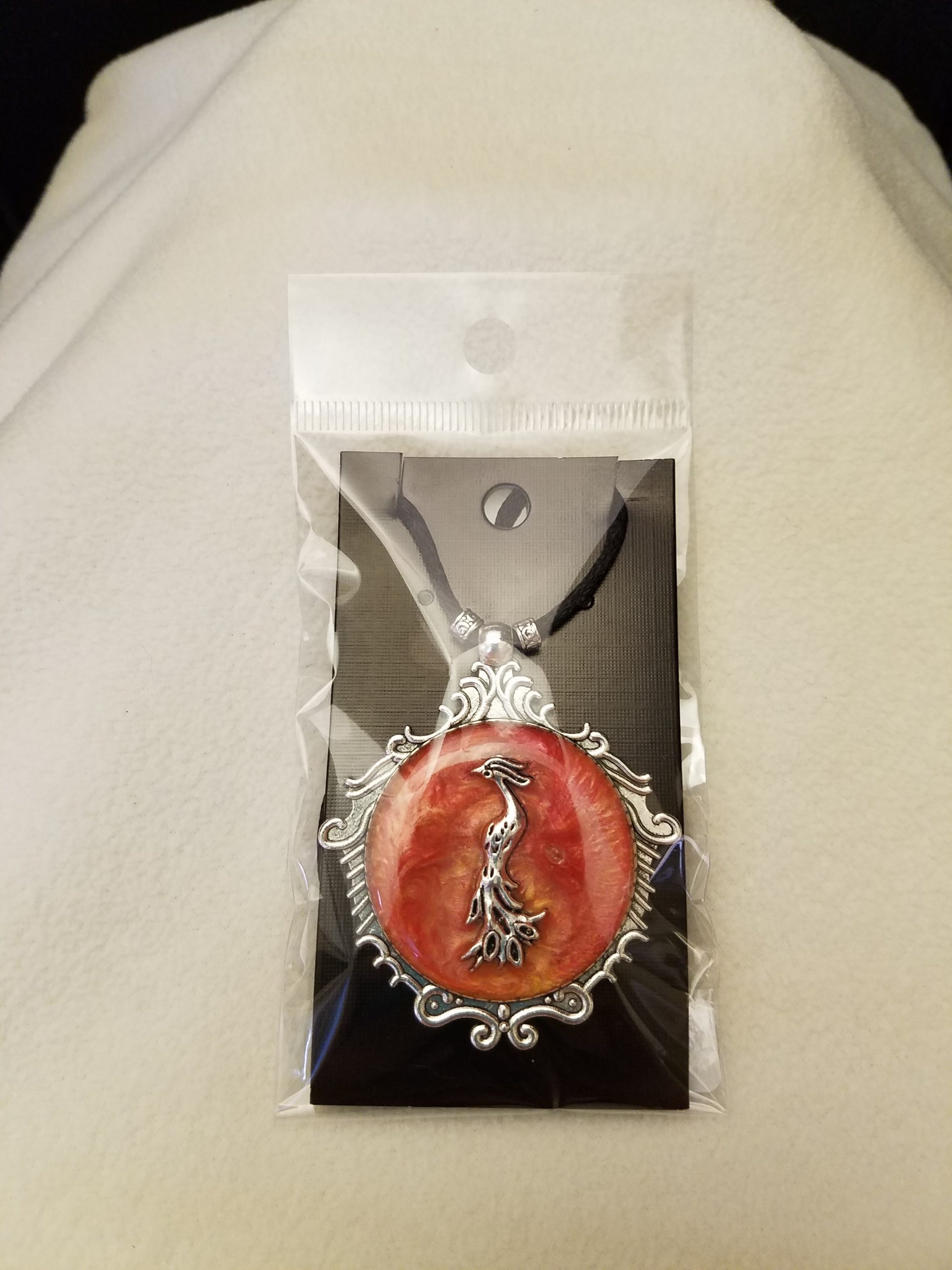 Black Cord Beaded Adjustable Necklace with Silver Phoenix Set in Orange Swirled Epoxy on Decorative Silver Pendant