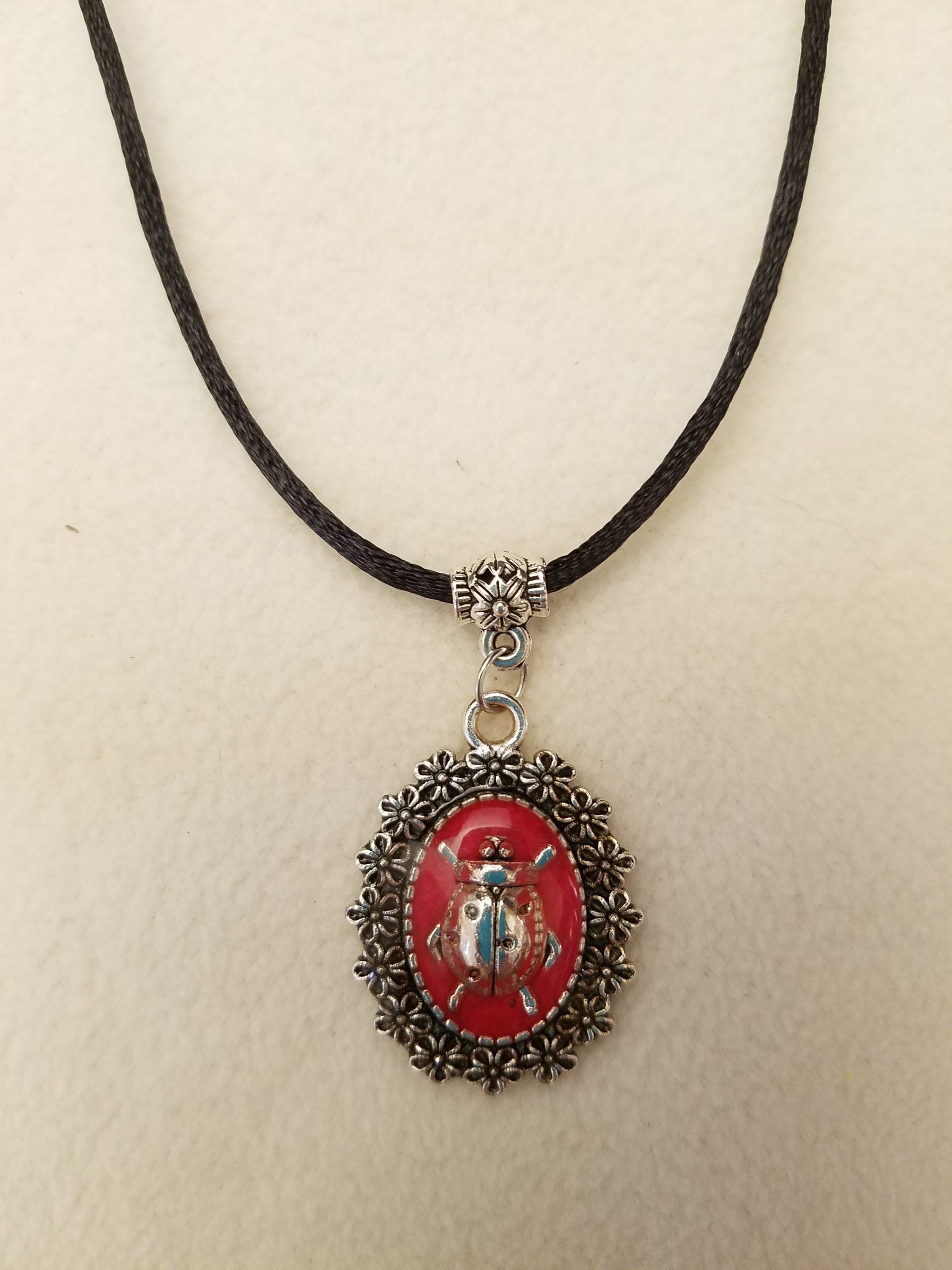 Silver Ladybug in Red Epoxy on Decorative Flower Pendant on Black Cord Necklace