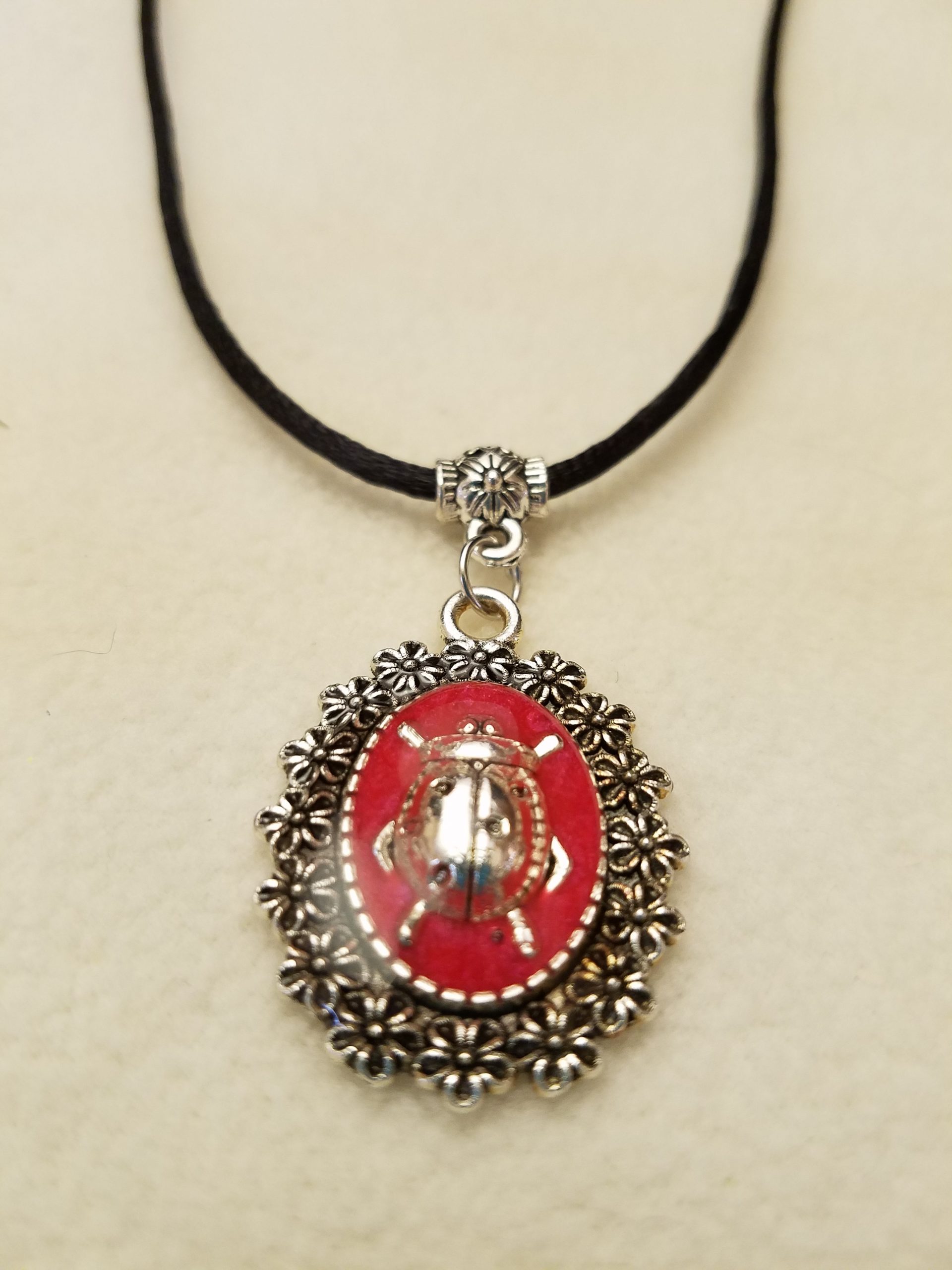 Silver Ladybug in Red Epoxy on Decorative Flower Pendant on Black Cord Necklace