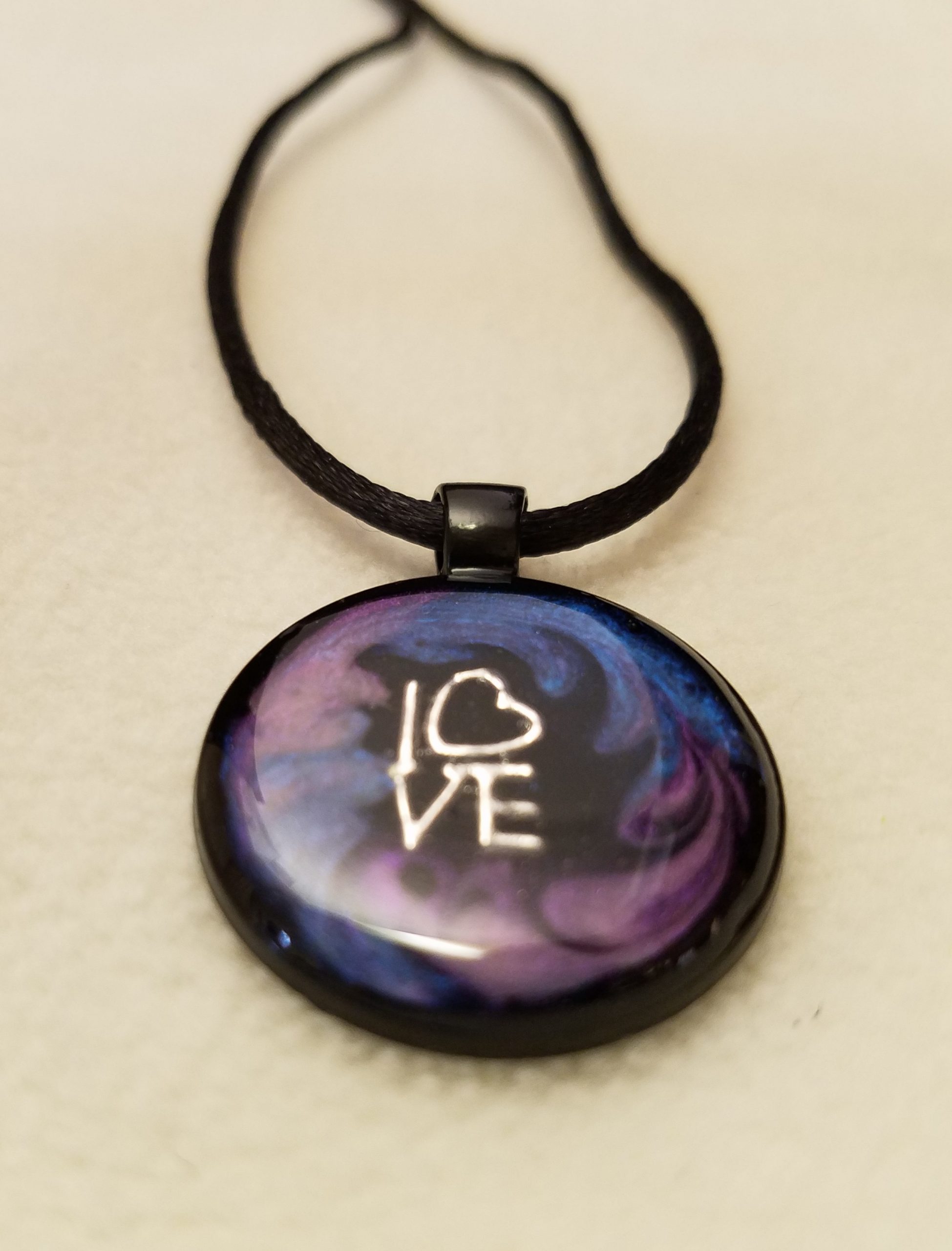 Silver 'LOVE' Charm in Purple & Blue Swirl Epoxy on Round Black Pendant on Black Cord Necklace