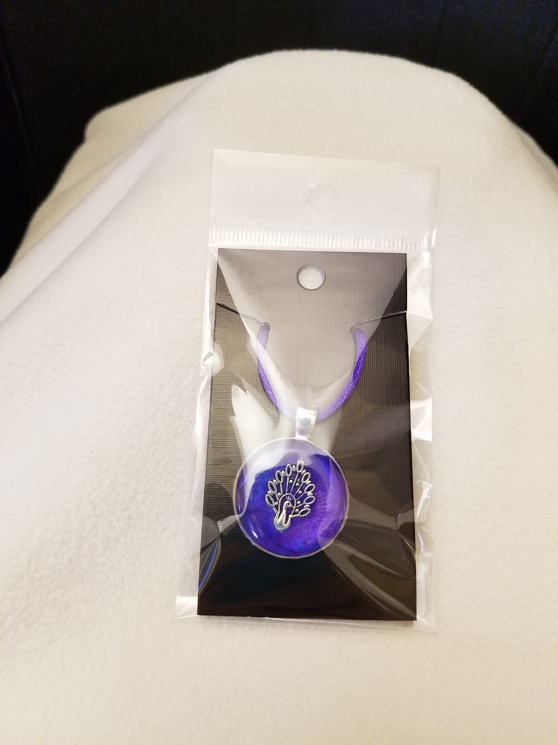 Adjustable Purple Cord Necklace with a Silver Peacock in Purple Epoxy on Round Silver Pendant