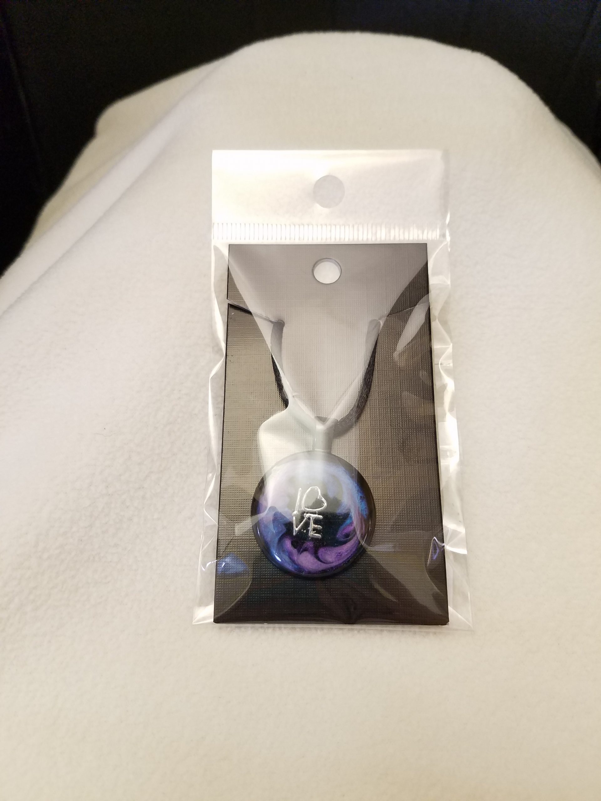 Adjustable Black Cord Necklace with a Silver 'LOVE' Charm in Purple & Blue Swirl Epoxy on Round Black Pendant