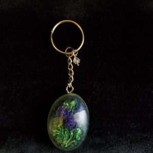 Oval Pendant Keychain Filled with Purple Flower Bouquet in Clear Glitter and Green Epoxy with Silver Flower Charm
