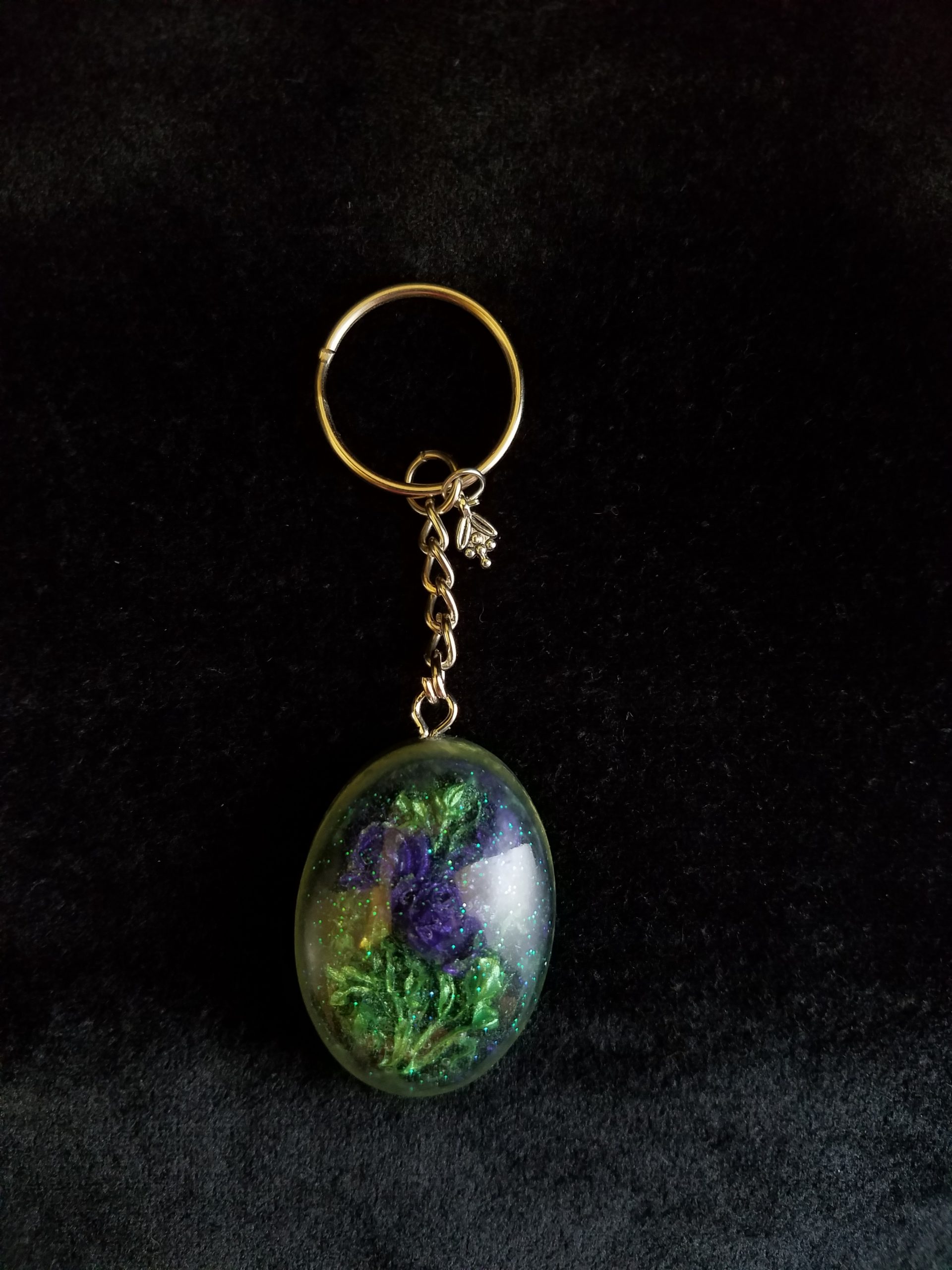 Oval Pendant Keychain Filled with Purple Flower Bouquet in Clear Glitter and Green Epoxy with Silver Flower Charm