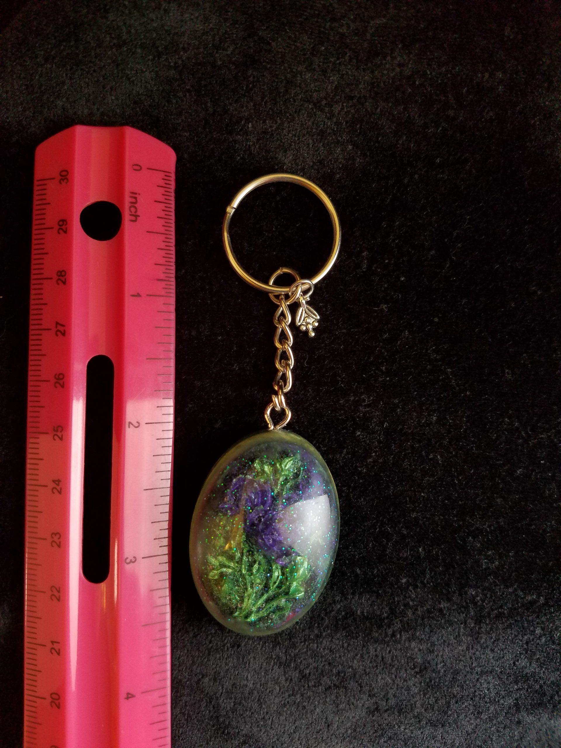 Oval Pendant Keychain Filled with Purple Flower Bouquet in Clear Glitter and Green Epoxy with Silver Flower Charm