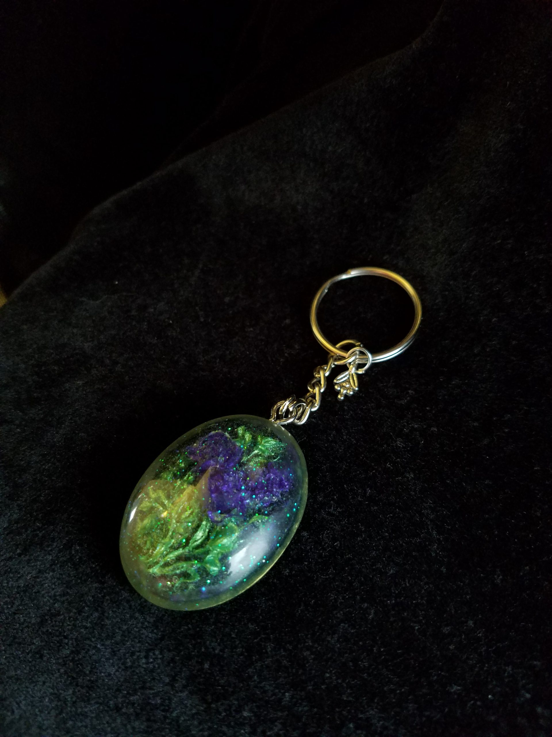 Oval Pendant Keychain Filled with Purple Flower Bouquet in Clear Glitter and Green Epoxy with Silver Flower Charm