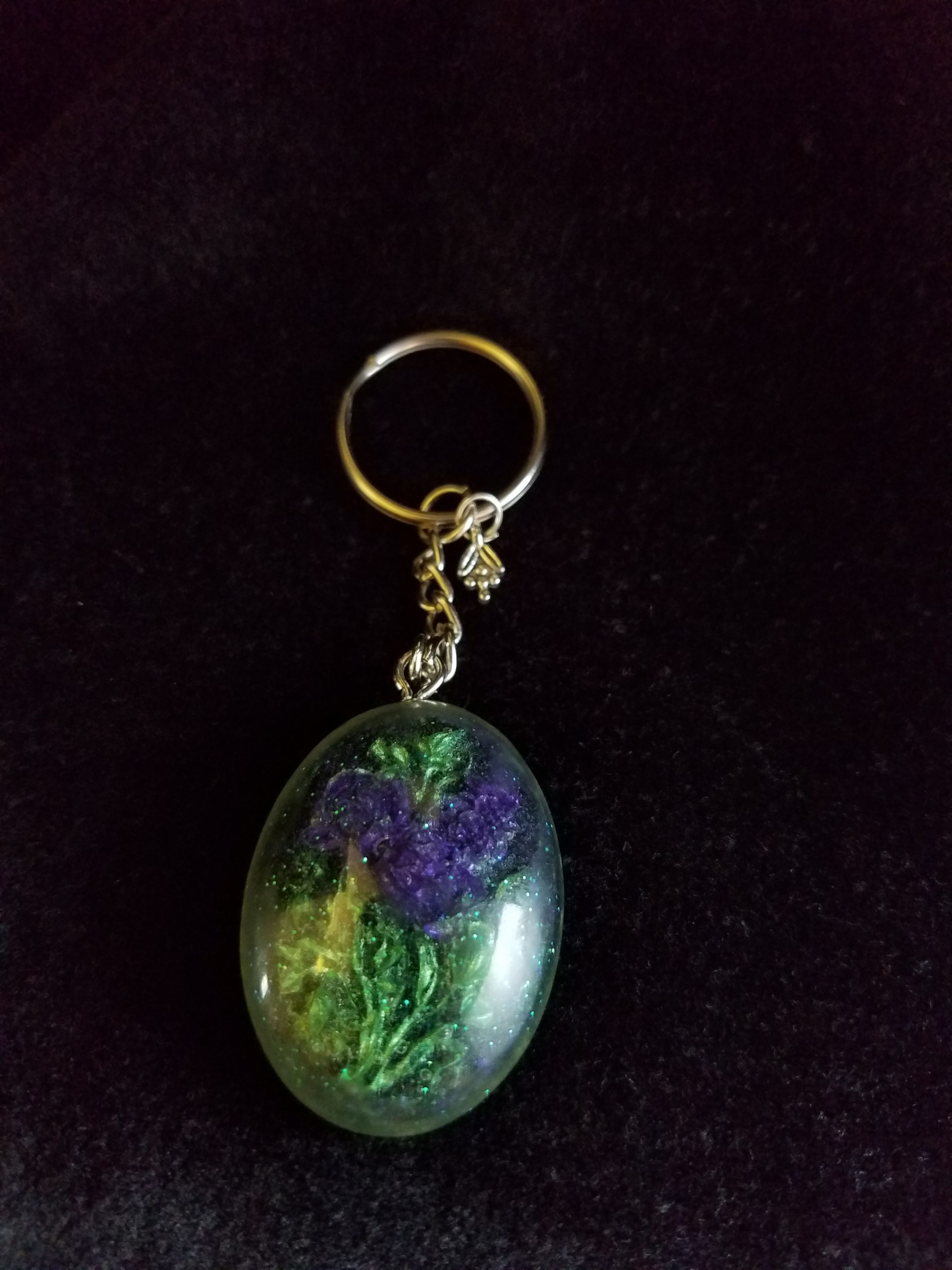 Oval Pendant Keychain Filled with Purple Flower Bouquet in Clear Glitter and Green Epoxy with Silver Flower Charm