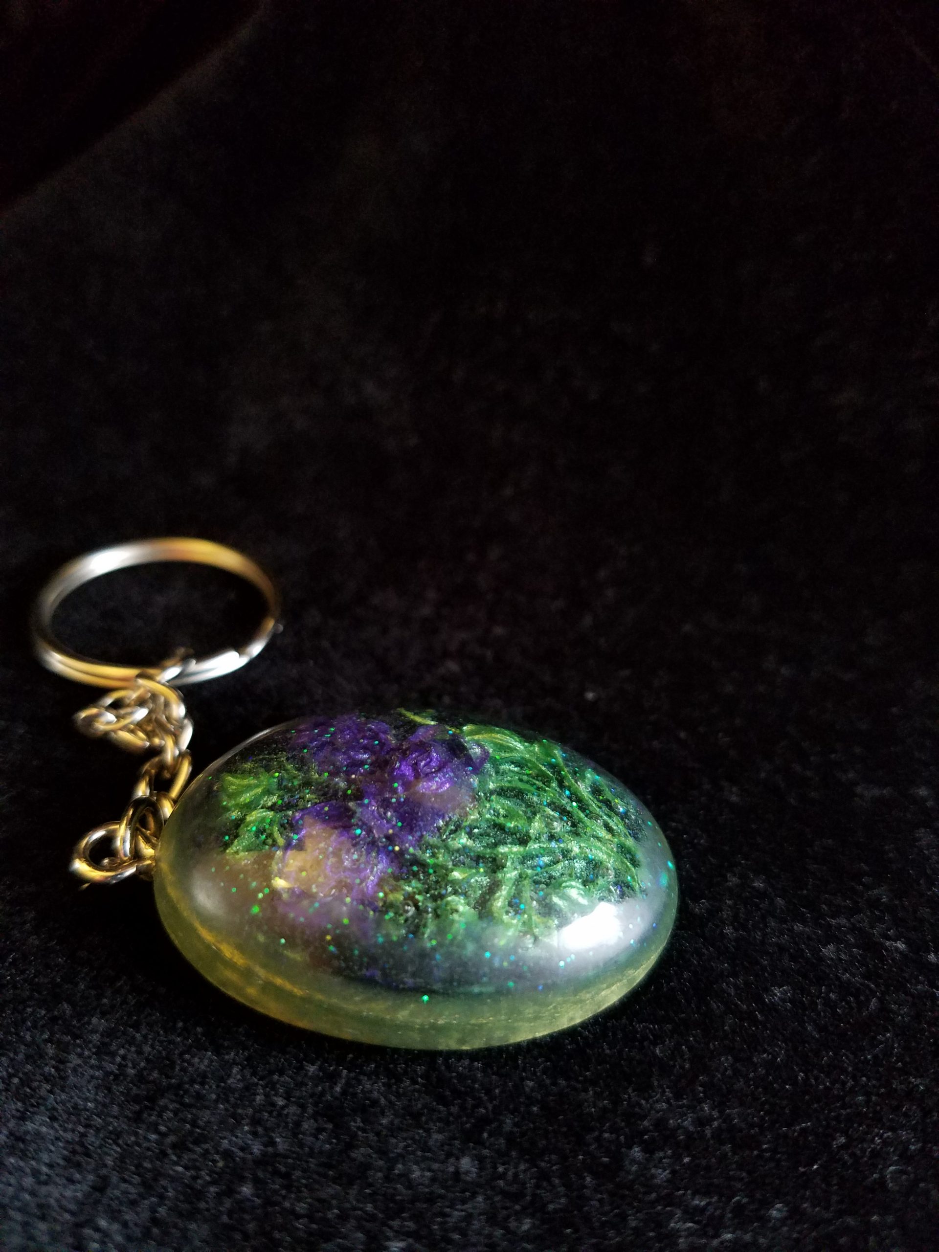 Oval Pendant Keychain Filled with Purple Flower Bouquet in Clear Glitter and Green Epoxy with Silver Flower Charm