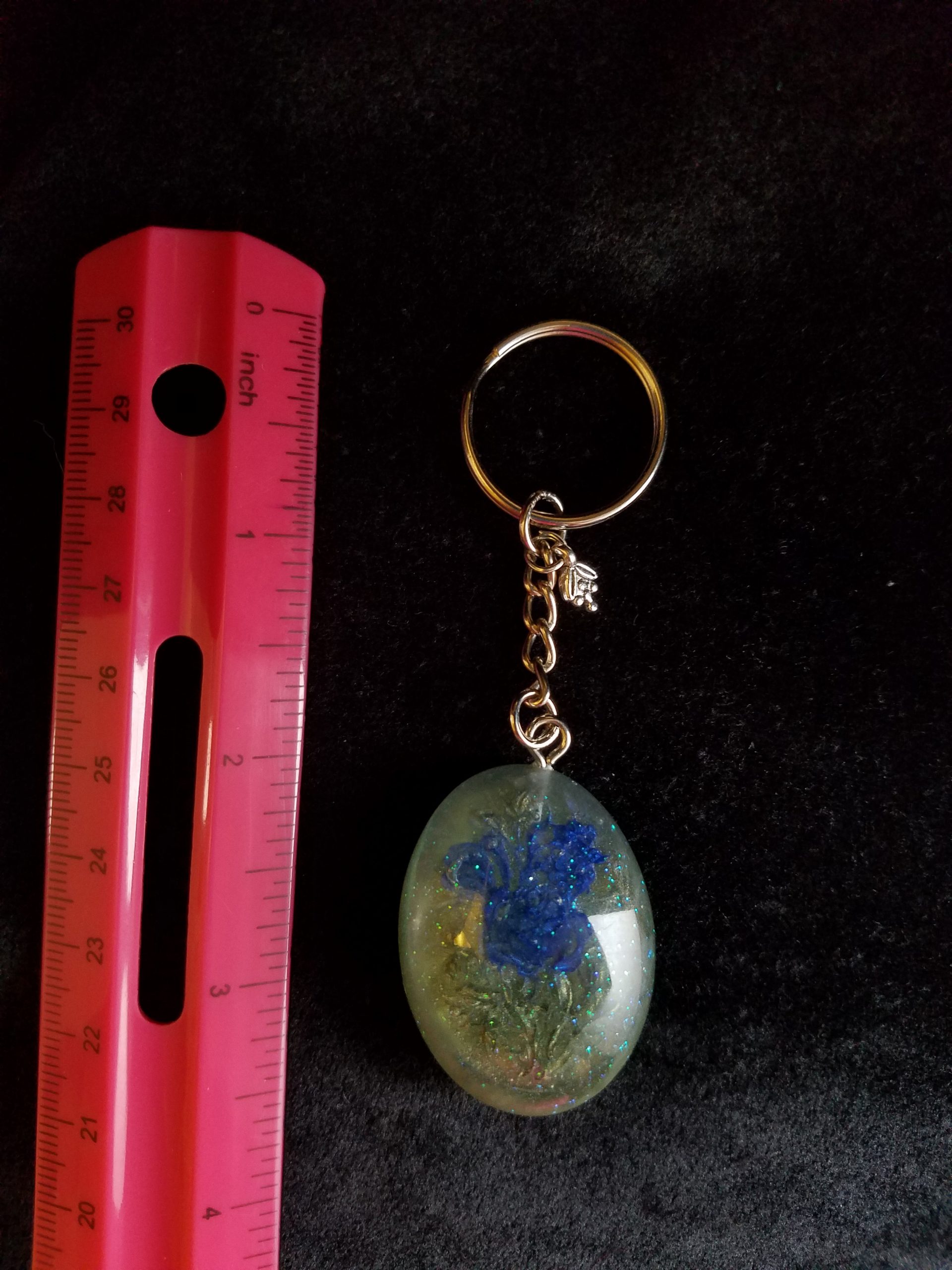 Oval Pendant Keychain Filled with Blue Flower Bouquet in Clear Glitter and Green Epoxy with Silver Flower Charm