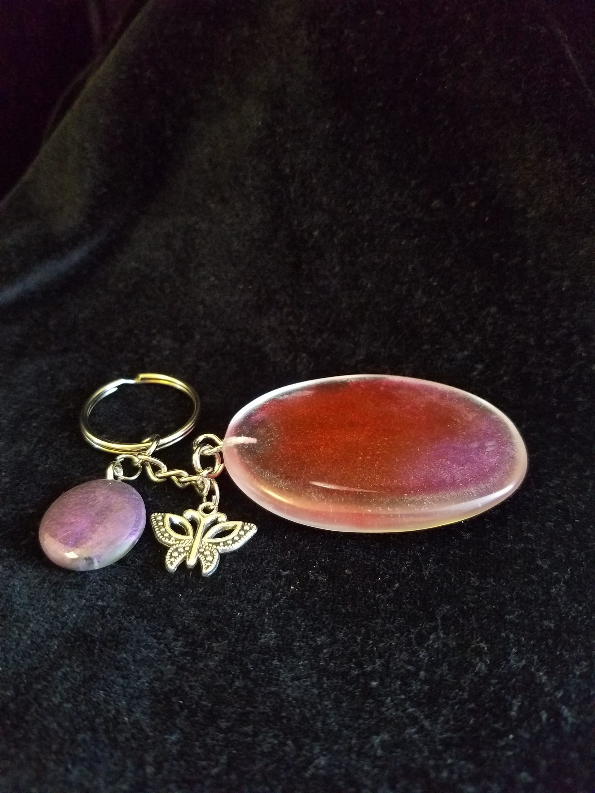 Abstract Clear Purple & Red Shimmery Oval Epoxy Pendant Keychain with Butterfly