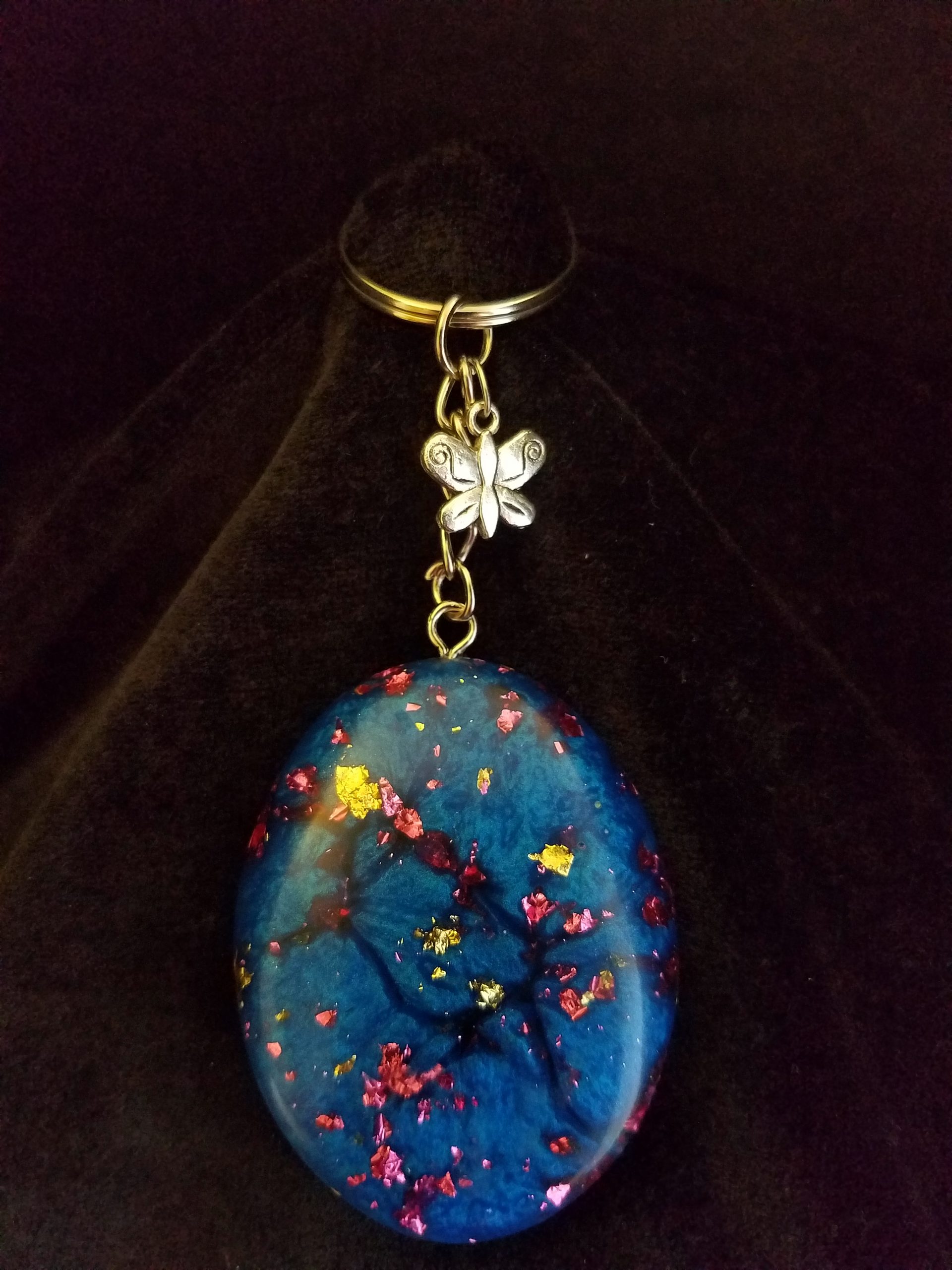 Abstract Shimmery Blue Oval Epoxy Pendant Keychain with Gold & Pink Foil Flakes & Silver Butterfly Charm