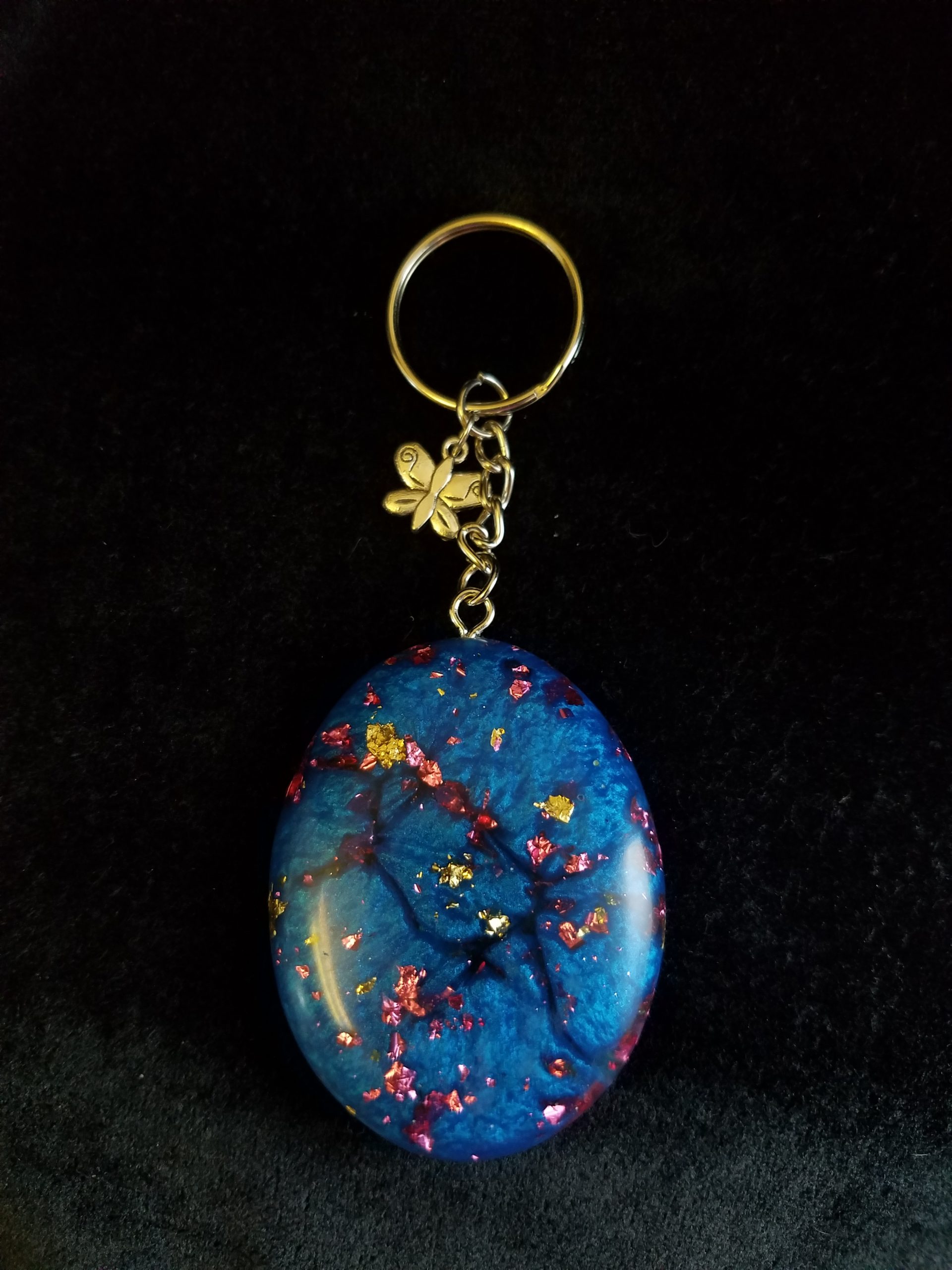 Abstract Shimmery Blue Oval Epoxy Pendant Keychain with Gold & Pink Foil Flakes & Silver Butterfly Charm