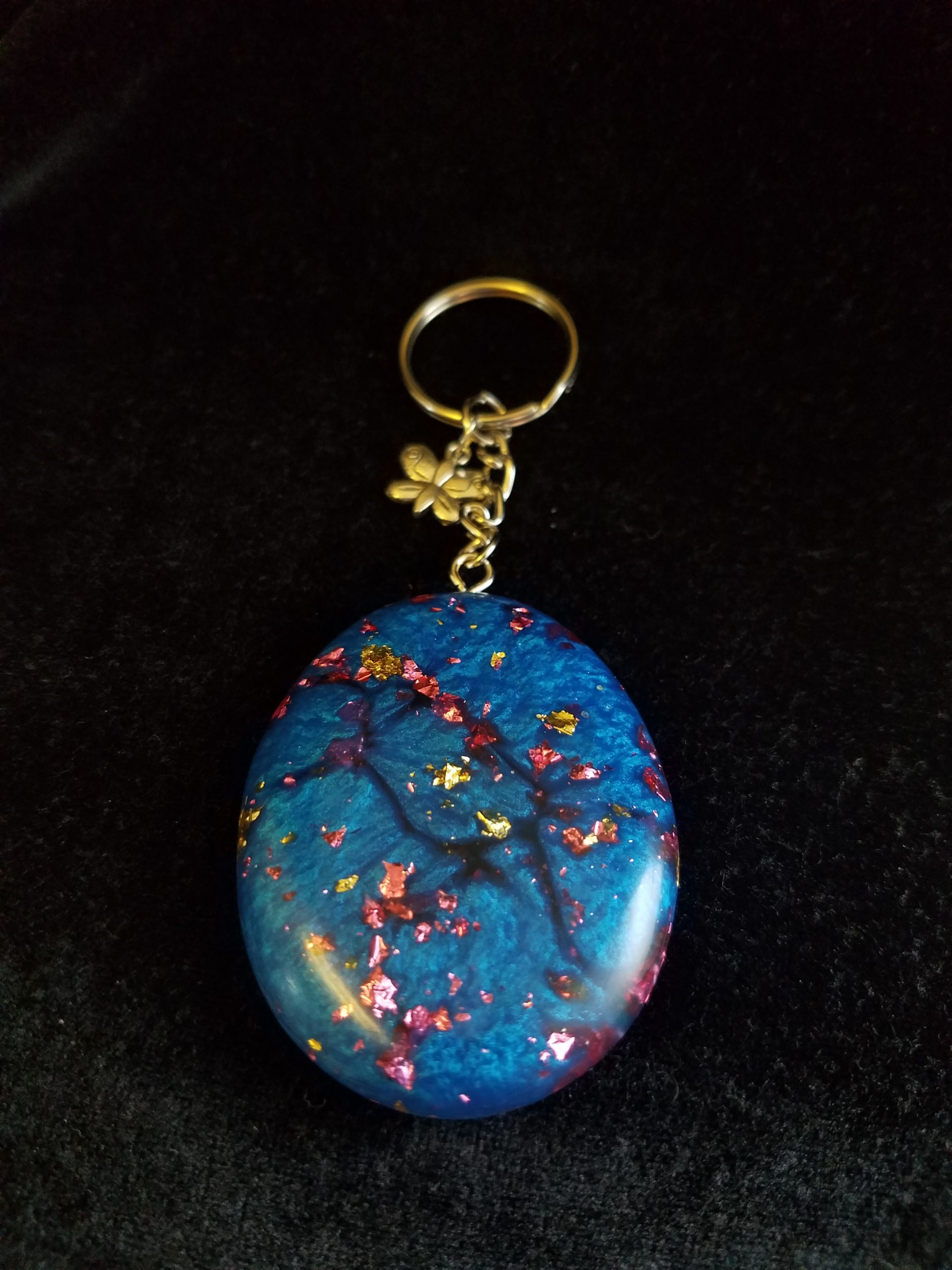 Abstract Shimmery Blue Oval Epoxy Pendant Keychain with Gold & Pink Foil Flakes & Silver Butterfly Charm