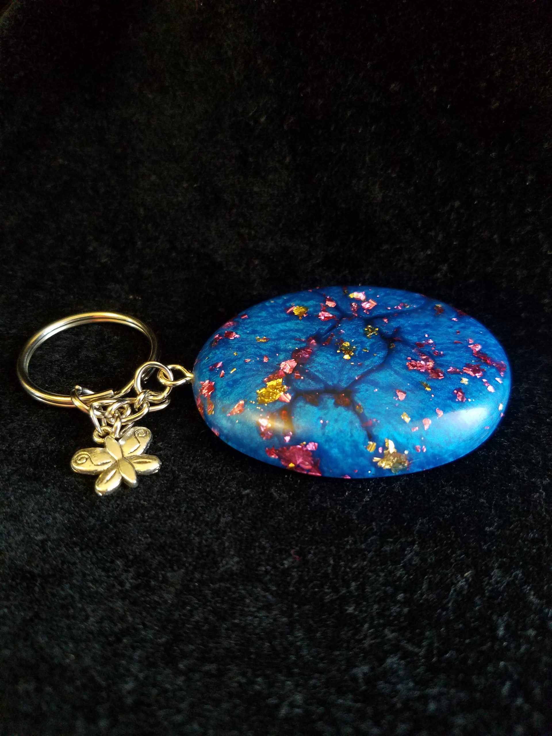 Abstract Shimmery Blue Oval Epoxy Pendant Keychain with Gold & Pink Foil Flakes & Silver Butterfly Charm