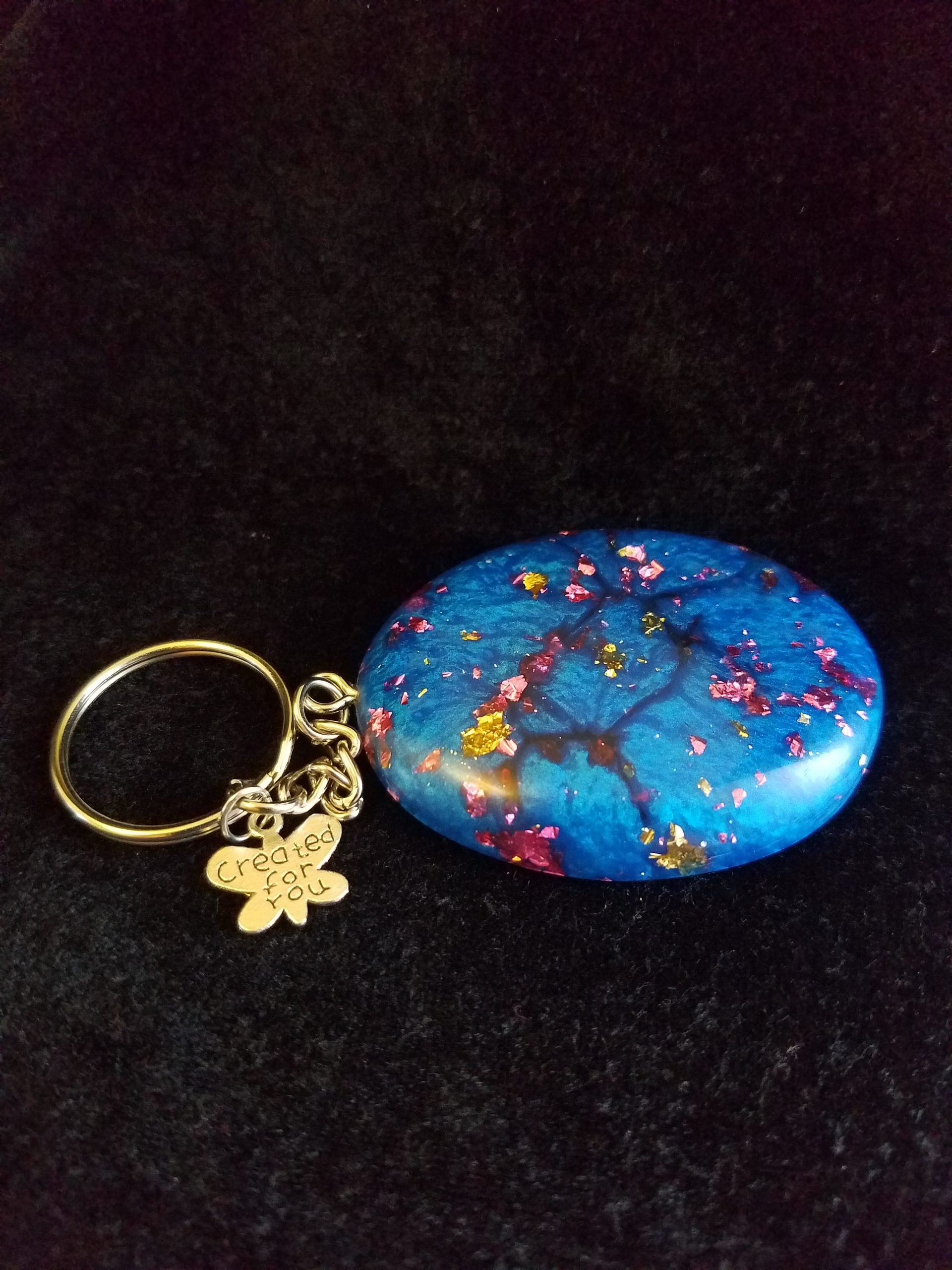 Abstract Shimmery Blue Oval Epoxy Pendant Keychain with Gold & Pink Foil Flakes & Silver Butterfly Charm