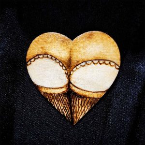 alt="Small 2 inch by 2 inch hand burned heart shaped wood slice magnet designed with a woman's round butt cheeks in lace panties and fishnet stocking thighs in the shape of the heart.">