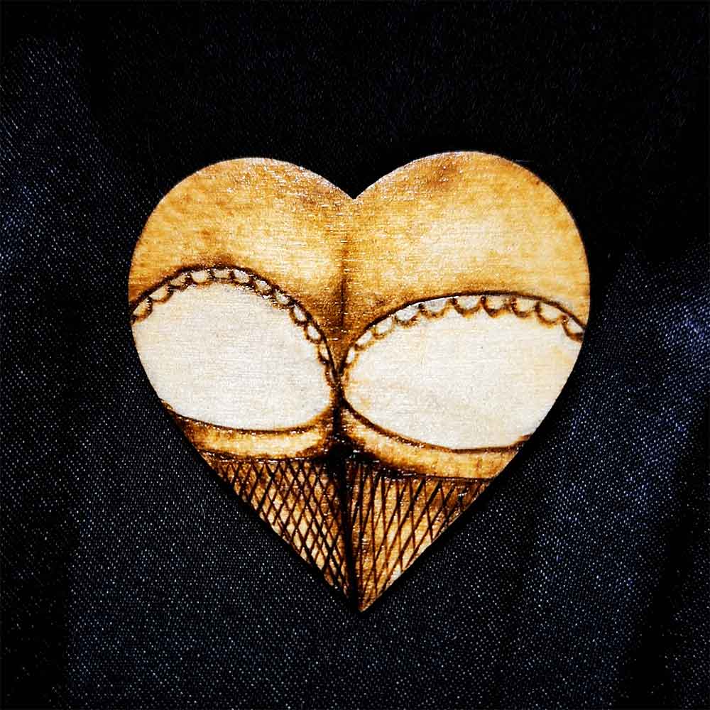 alt="Small 2 inch by 2 inch hand burned heart shaped wood slice magnet designed with a woman's round butt cheeks in lace panties and fishnet stocking thighs in the shape of the heart.">