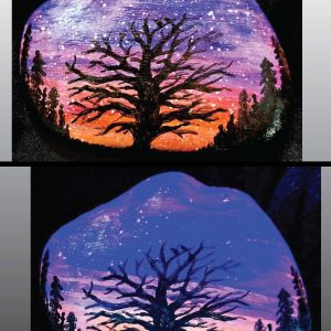 alt="Collage view with 2 images of a hand painted in acrylic paint 3 by 2.5 inch smooth rock with a neon orange red pink and purple blended sunset in the background with a black silhouette in the foreground containing an image of a country scene with a branchy leafless tree and grass in the center of the rock with full pine trees filling hills that are framing the far left and right sides of the rock, one viewed in regular light and one viewed under black light.">