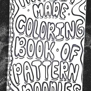 alt="Horizontal ruler measuring a 12x6 inch front color-it-yourself cover of a black spiral bound coloring book titled Artist Made Coloring Book Of Pattern Doodles.">